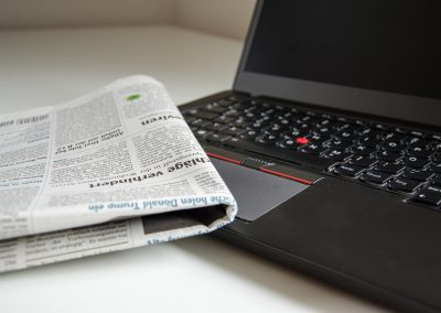 Image of newspaper sitting on a computer