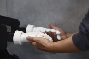 Image of robot and human hands connecting from “Shall We Dance? Resonance of Intentions with an Embodied Agent based on the Free Energy Principle”